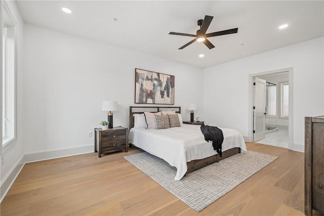 bedroom featuring multiple windows, ceiling fan, and light hardwood / wood-style flooring