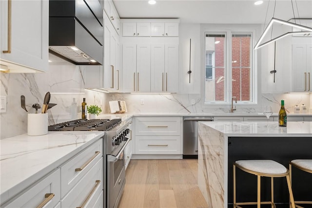 kitchen featuring white cabinetry, a healthy amount of sunlight, and appliances with stainless steel finishes