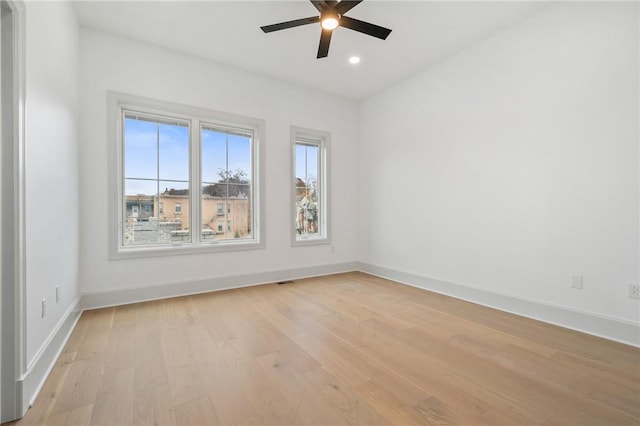 unfurnished room featuring light hardwood / wood-style flooring and ceiling fan