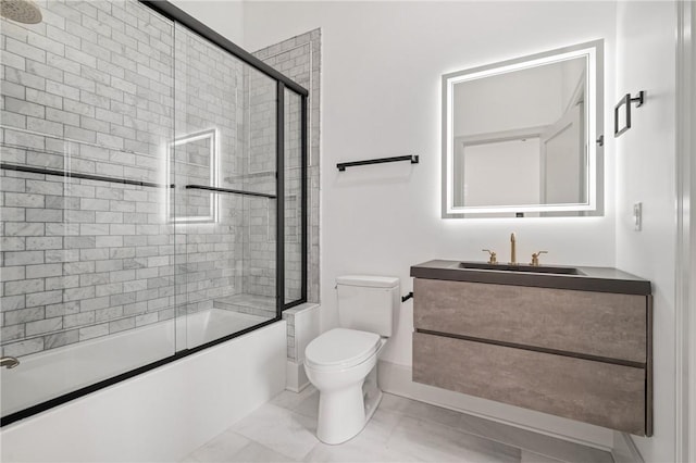 full bathroom featuring vanity, toilet, and shower / bath combination with glass door