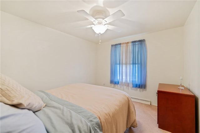 bedroom featuring light colored carpet, baseboard heating, and ceiling fan