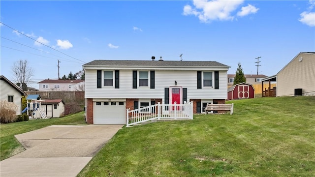 raised ranch featuring a storage unit, a garage, and a front lawn