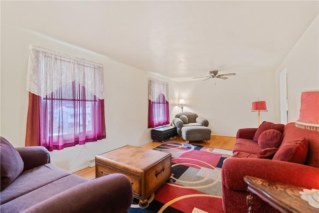 living room featuring hardwood / wood-style floors and ceiling fan