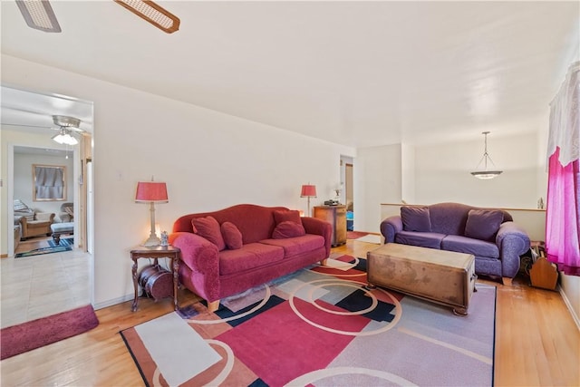 living room featuring ceiling fan and light hardwood / wood-style flooring