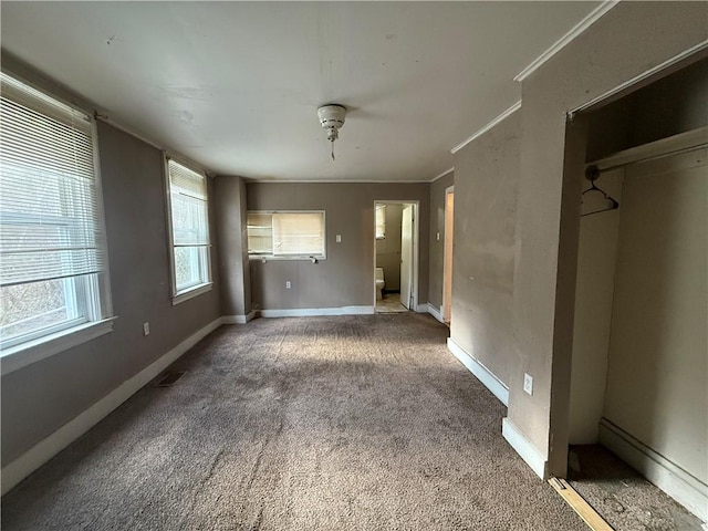 unfurnished bedroom featuring carpet flooring and crown molding