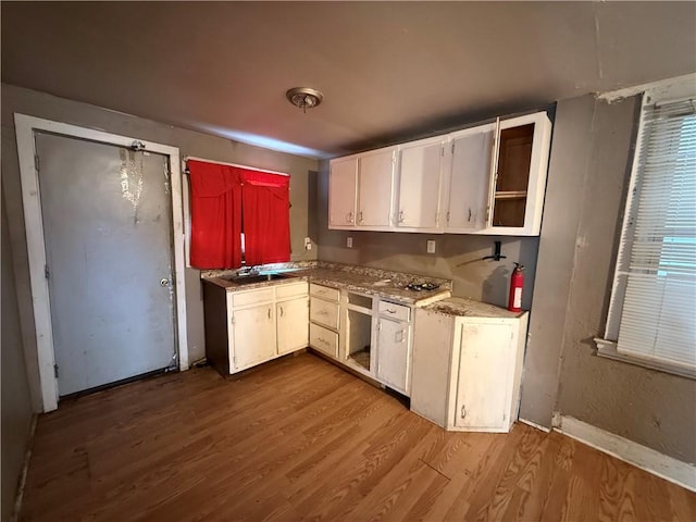 kitchen featuring light hardwood / wood-style flooring and white cabinetry