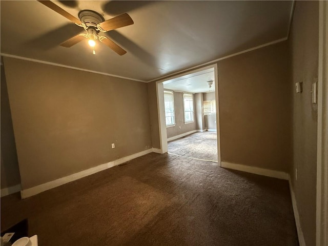 carpeted spare room featuring ceiling fan and ornamental molding