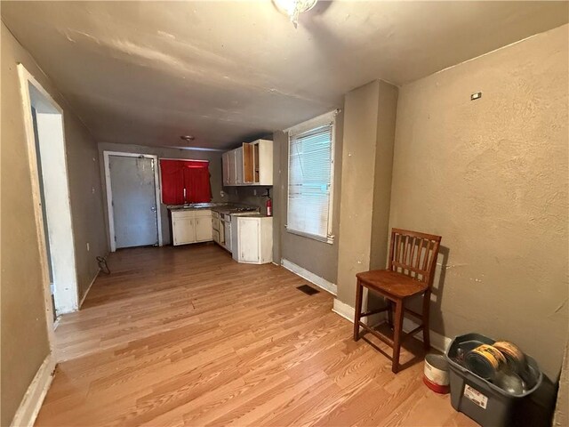 kitchen featuring light wood-type flooring and stainless steel stove