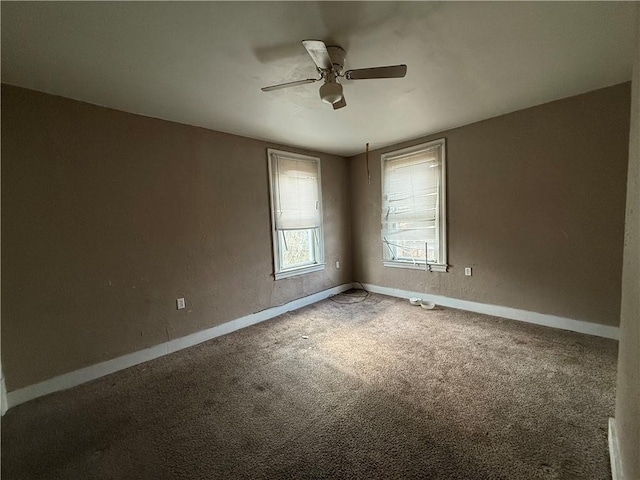 empty room featuring carpet floors and ceiling fan