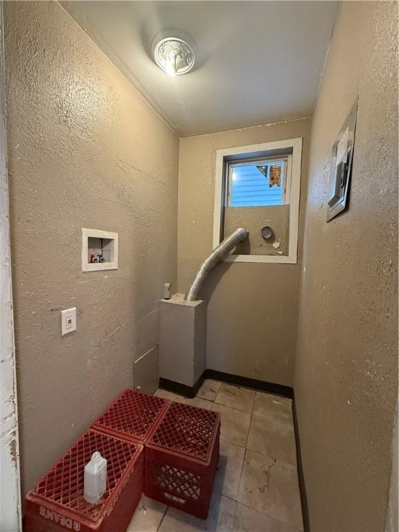 laundry area with washer hookup and light tile patterned floors