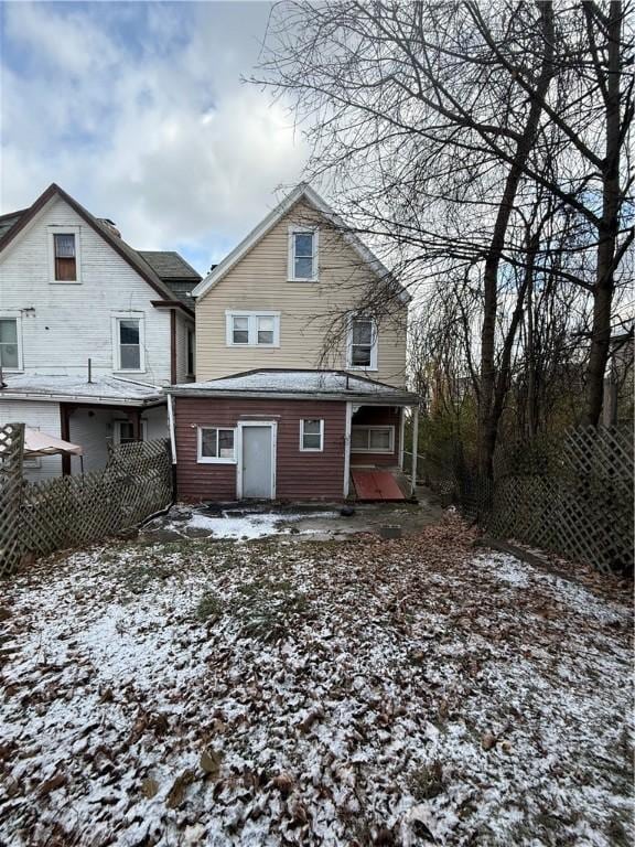 view of snow covered rear of property