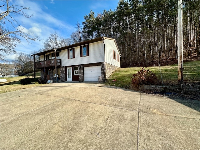 view of front of house with a front yard, a deck, and a garage