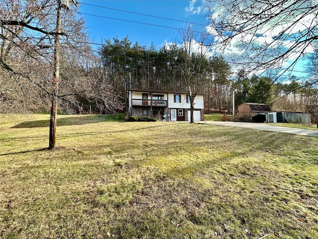 view of front of property with a garage and a front lawn