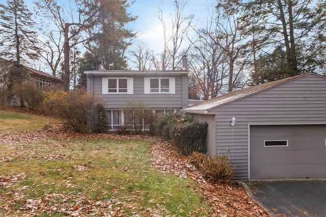 view of property featuring a front yard and a garage