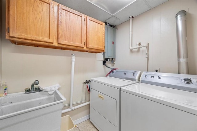 clothes washing area featuring washing machine and clothes dryer, sink, cabinets, electric panel, and light tile patterned floors