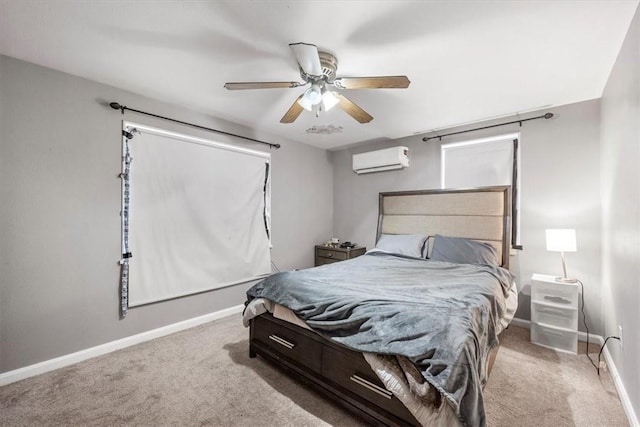 bedroom with ceiling fan, light colored carpet, and an AC wall unit