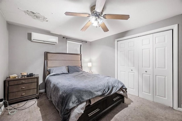 carpeted bedroom with ceiling fan, a closet, and a wall mounted air conditioner