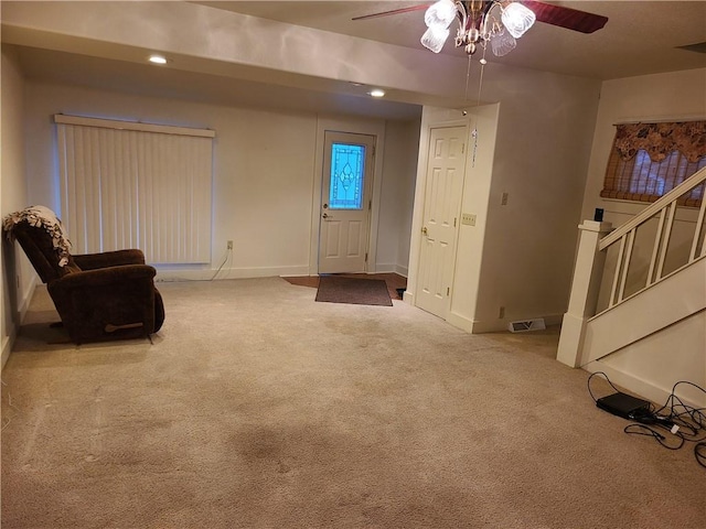 interior space featuring carpet flooring and ceiling fan