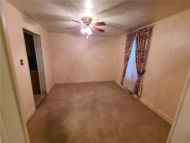 unfurnished room with light colored carpet and ceiling fan