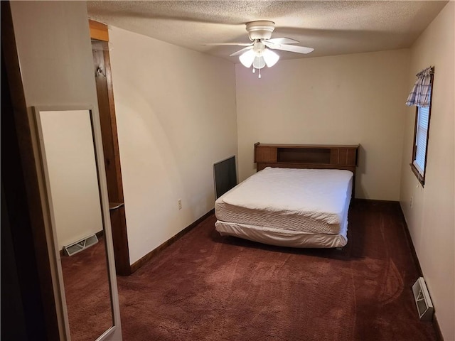 carpeted bedroom with a textured ceiling and ceiling fan