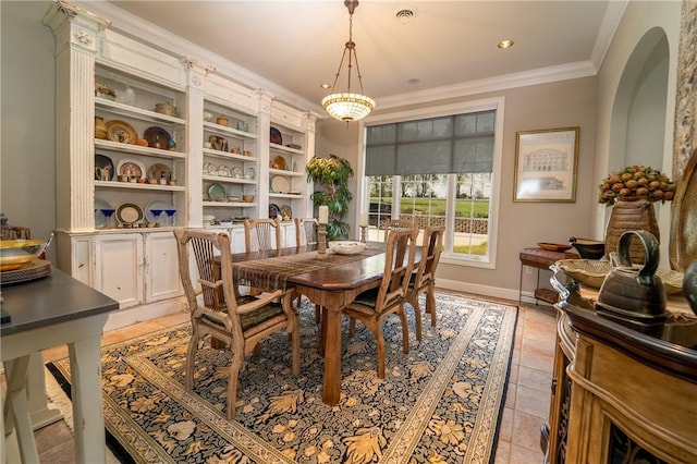 tiled dining room with an inviting chandelier and ornamental molding