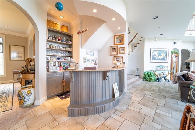 bar with built in shelves and crown molding