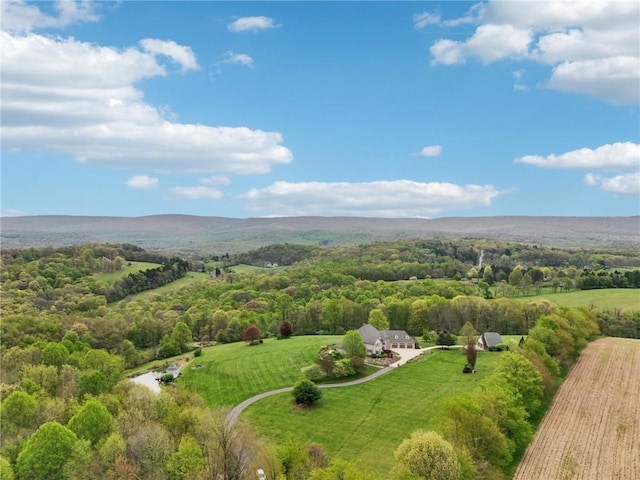 aerial view featuring a rural view and a wooded view