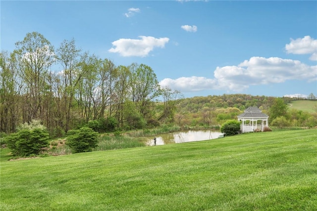 view of yard with a gazebo and a water view