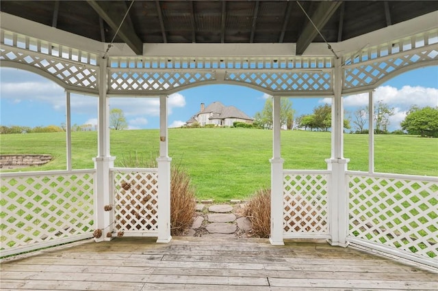 wooden terrace featuring a yard