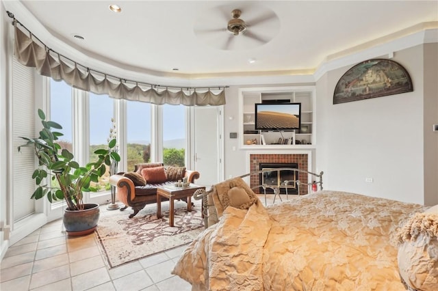 bedroom featuring a tiled fireplace, recessed lighting, light tile patterned flooring, and multiple windows