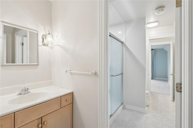 full bathroom with vanity, baseboards, tile patterned floors, and a shower stall