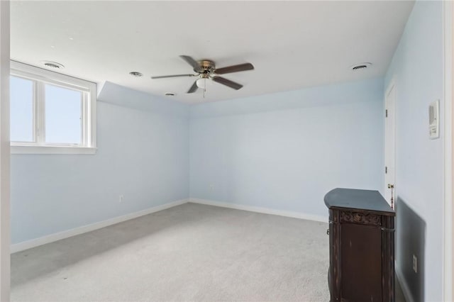 interior space featuring visible vents, a ceiling fan, and baseboards