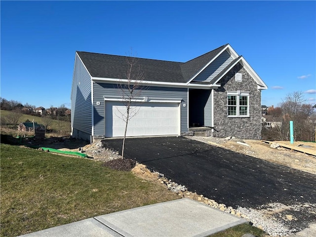 view of front of property featuring a front yard and a garage