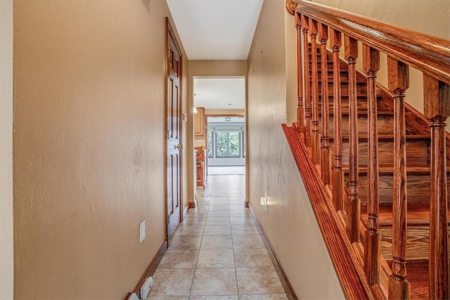 hall with light tile patterned floors