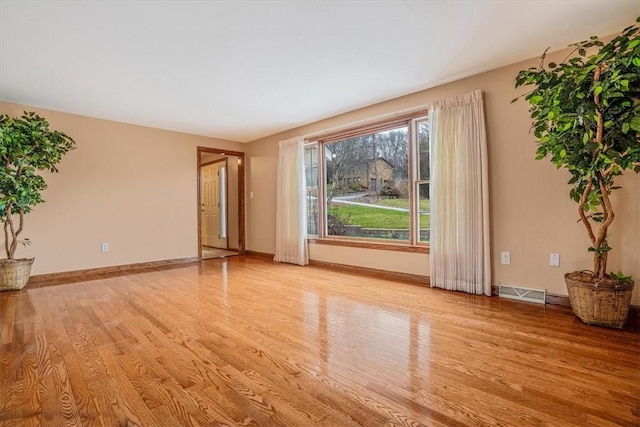 spare room featuring light hardwood / wood-style floors