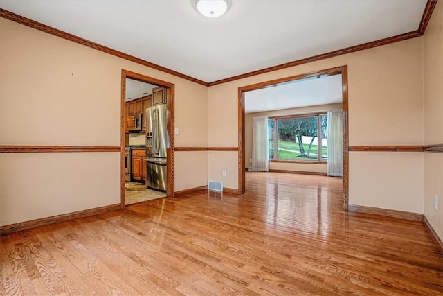 unfurnished room with light hardwood / wood-style flooring and ornamental molding