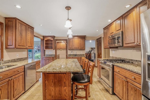 kitchen featuring a kitchen island, light tile patterned floors, a breakfast bar area, and appliances with stainless steel finishes