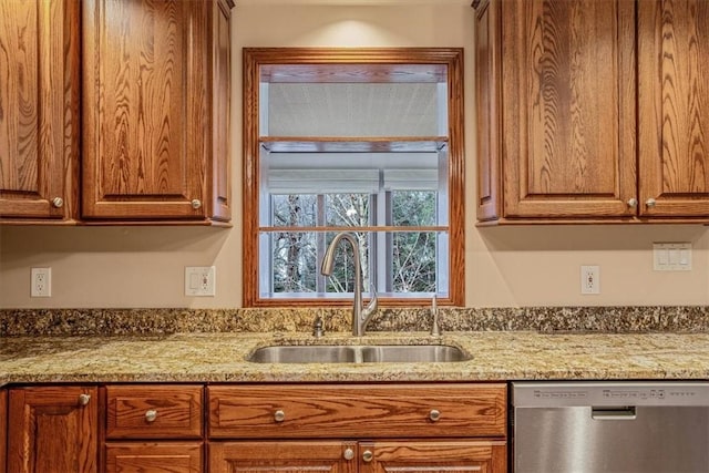 kitchen with dishwasher, light stone countertops, and sink