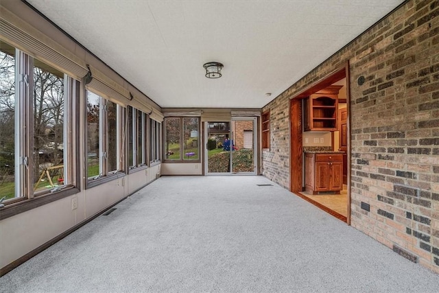 unfurnished sunroom featuring a wealth of natural light