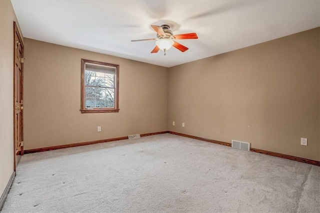 empty room with ceiling fan and light colored carpet