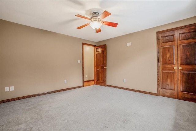 unfurnished bedroom featuring ceiling fan and light colored carpet