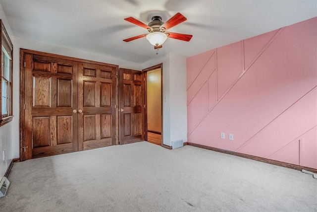 unfurnished bedroom with ceiling fan and light carpet