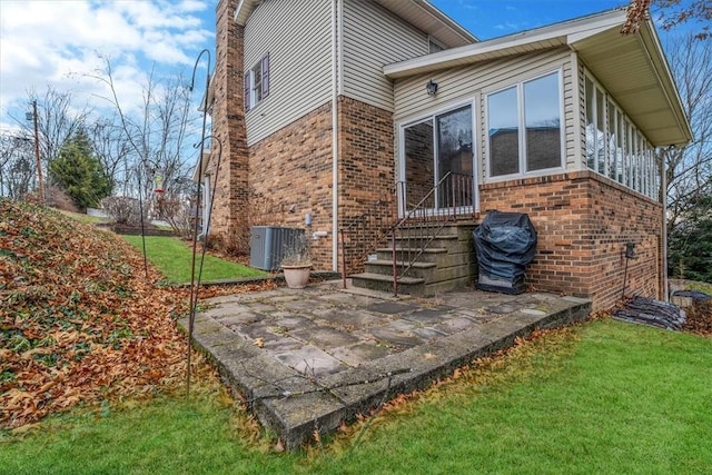 exterior space with a patio, central AC, and a lawn