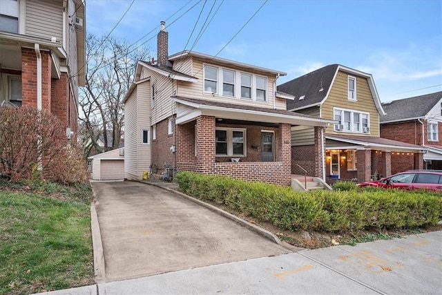 view of front of home with a garage and an outdoor structure