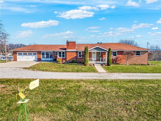 ranch-style house with a garage and a front lawn