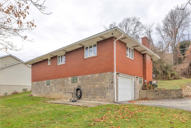 view of property exterior with a lawn and a garage