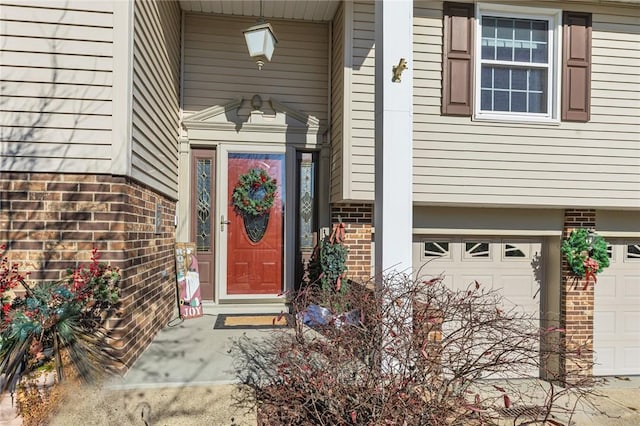 view of exterior entry with a garage