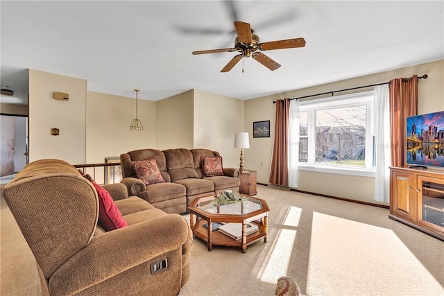 carpeted living room with ceiling fan