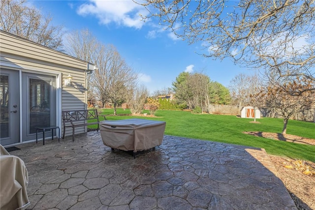 view of patio / terrace featuring a storage unit