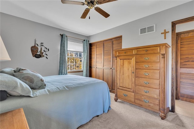 carpeted bedroom featuring ceiling fan and a closet